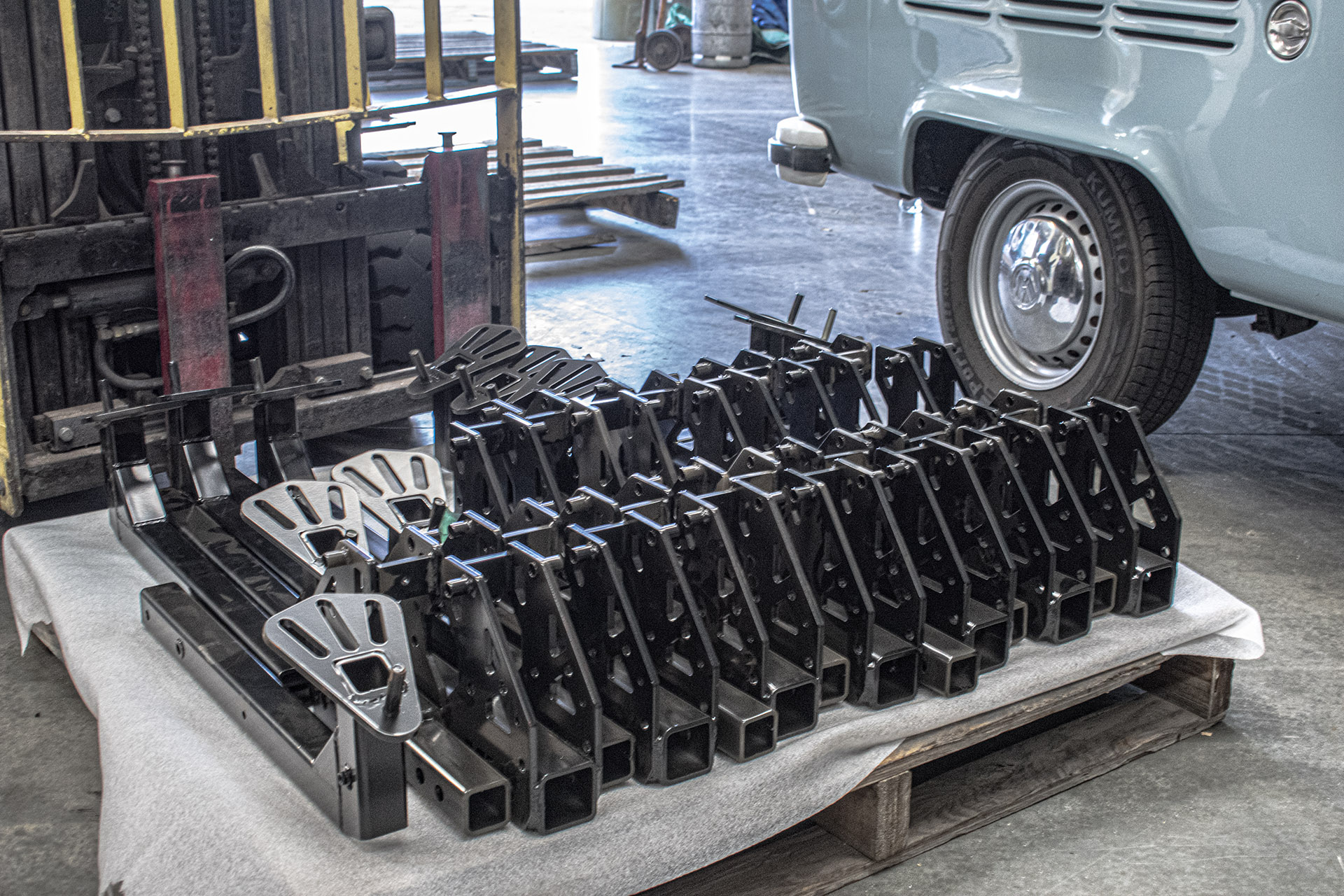 Batch of fabricated and coated steel frames on a pallet in the MiWeld workshop