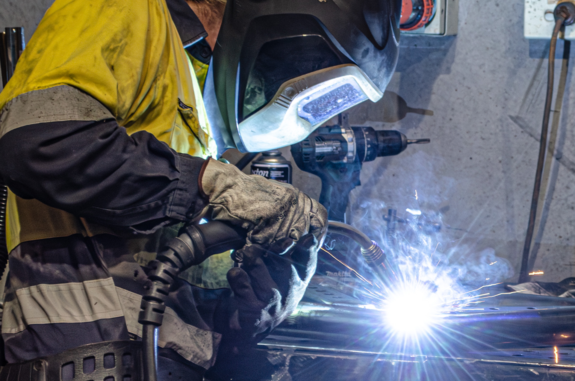 MiWeld welder MIG welding automotive swing carriers with sparks flying