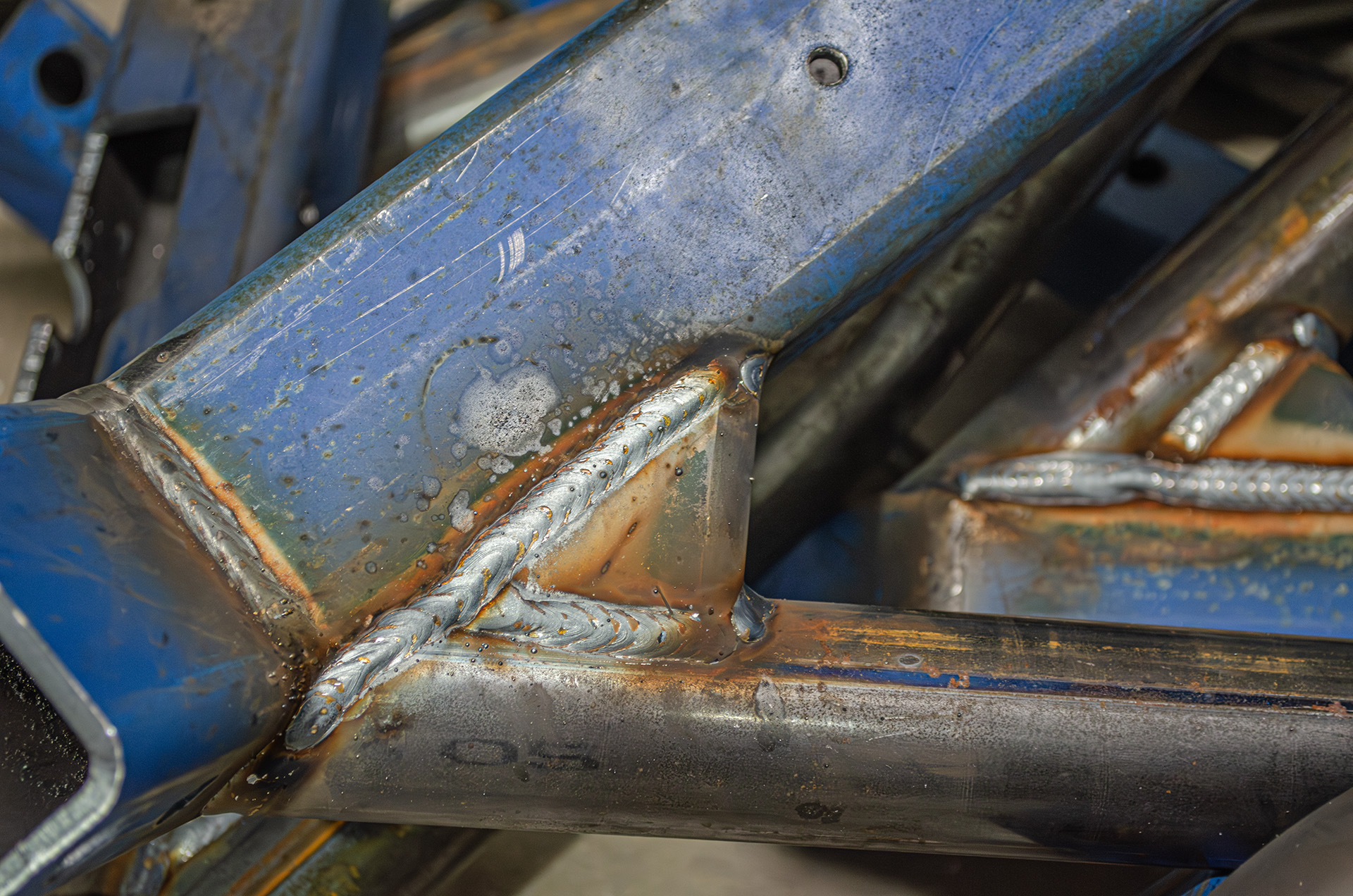 Close-up of MiWeld fillet welds on a steel vehicle chassis component